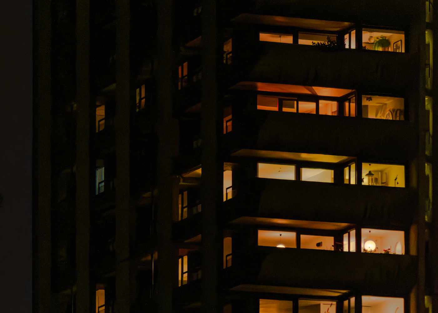 Warm lights in the windows and balconies of London’s Barbican at night